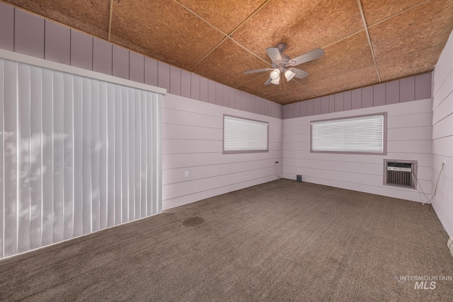 1040 N Pennsylvania Ave, Fruitland, ID 83619 - carpeted spare room featuring a ceiling fan, a wall unit AC, and wood walls