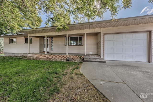 1040 N Pennsylvania Ave, Fruitland, ID 83619 - ranch-style home with a porch, concrete driveway, an attached garage, and a front yard