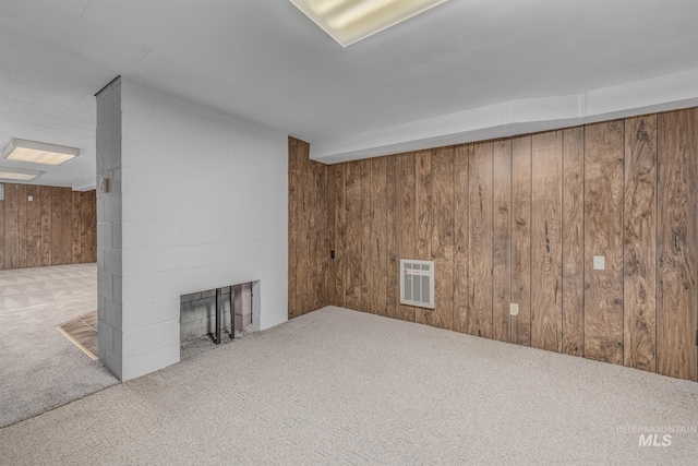 1040 N Pennsylvania Ave, Fruitland, ID 83619 - unfurnished living room featuring carpet flooring, wooden walls, and a fireplace