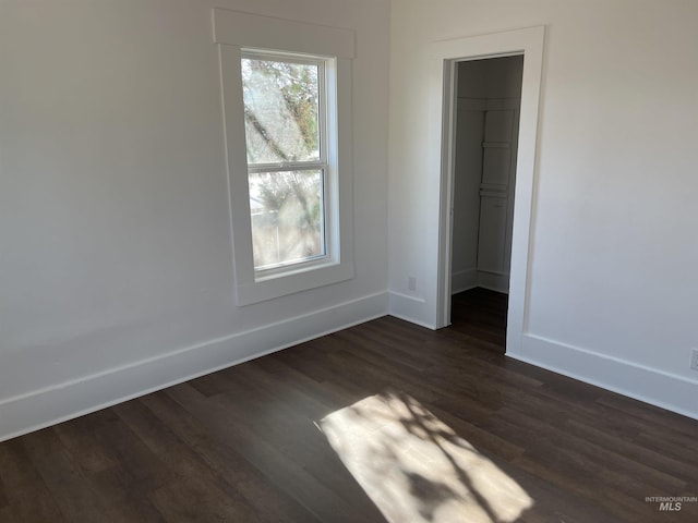 195 SE 2nd St, Ontario, OR 97914 - unfurnished bedroom with a walk in closet, dark wood-type flooring, and a closet