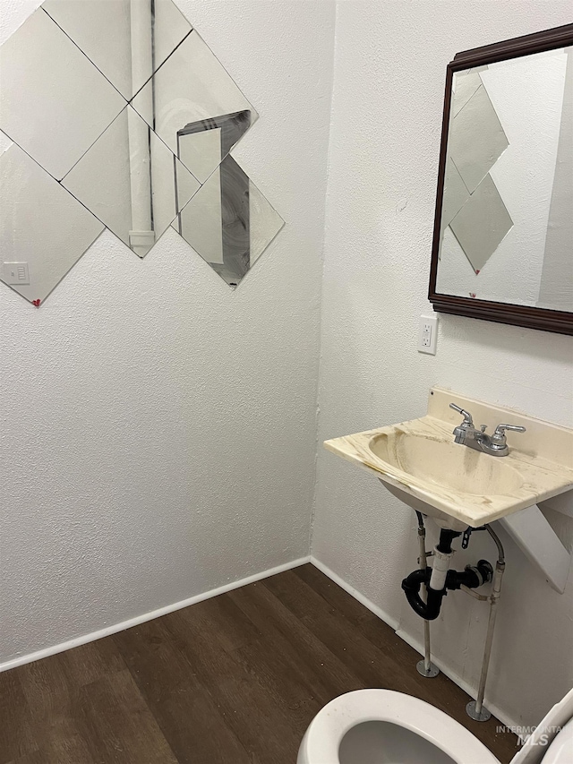 195 SE 2nd St, Ontario, OR 97914 - bathroom featuring wood-type flooring, toilet, and sink