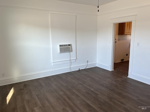 195 SE 2nd St, Ontario, OR 97914 - empty room with a wall mounted air conditioner and dark hardwood / wood-style flooring