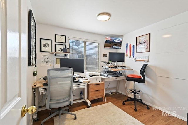 office with baseboards and wood finished floors