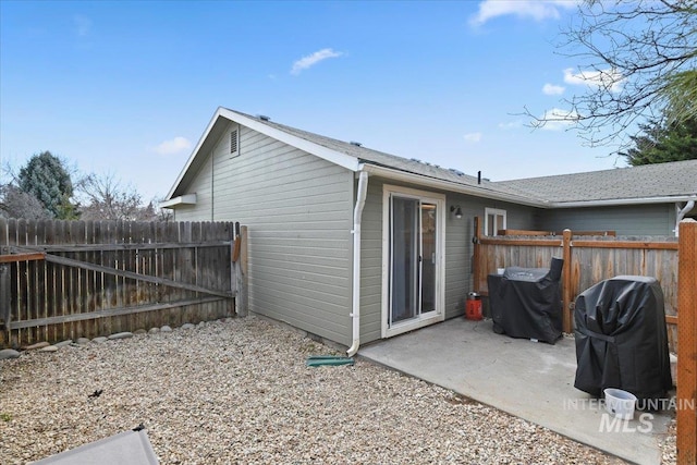 rear view of property with a patio and fence