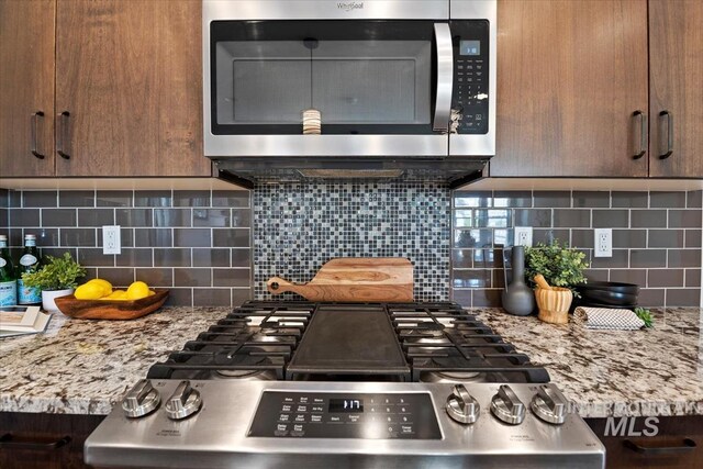 3671 S Pheasant Tail Way, Boise, ID 83716 - kitchen with stainless steel microwave, stove, and backsplash