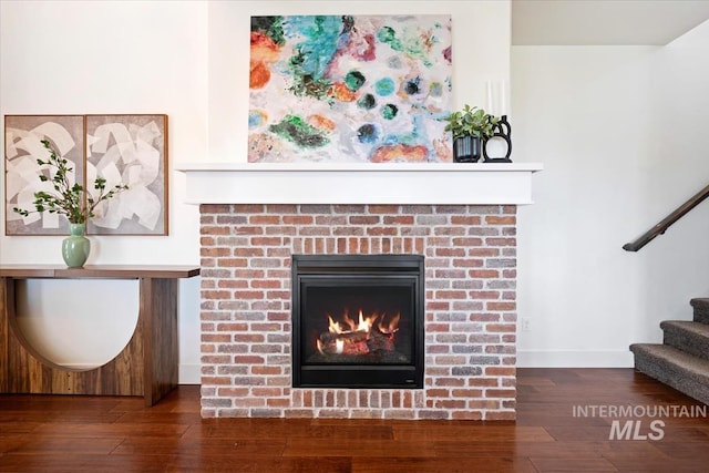 3671 S Pheasant Tail Way, Boise, ID 83716 - detailed view of wood finished floors, baseboards, and a brick fireplace