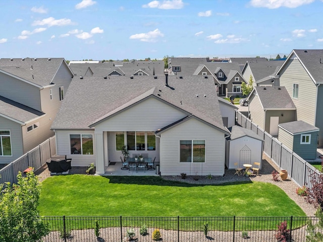 10366 Loneleaf Dr, Nampa, ID 83687 - rear view of property with a residential view, a patio area, a shingled roof, and a shed