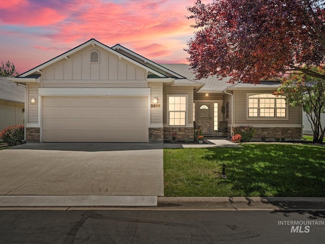 3369 W Monessen Ln, Meridian, ID 83646 - view of front facade with stone siding, an attached garage, and concrete driveway