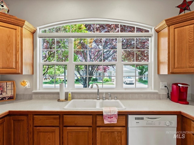 3369 W Monessen Ln, Meridian, ID 83646 - kitchen with white dishwasher, light countertops, and brown cabinetry