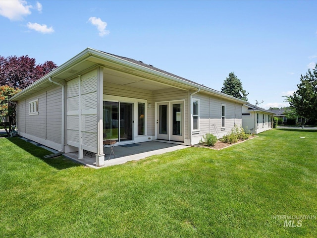 3369 W Monessen Ln, Meridian, ID 83646 - back of property featuring a lawn and a patio area