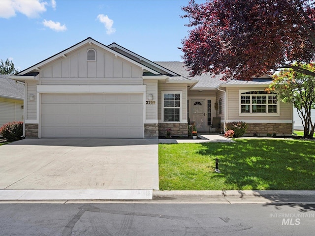 3369 W Monessen Ln, Meridian, ID 83646 - view of front of property with stone siding, an attached garage, concrete driveway, a front yard, and board and batten siding