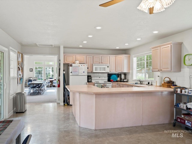 3369 W Monessen Ln, Meridian, ID 83646 - kitchen featuring white appliances, healthy amount of natural light, tasteful backsplash, and recessed lighting