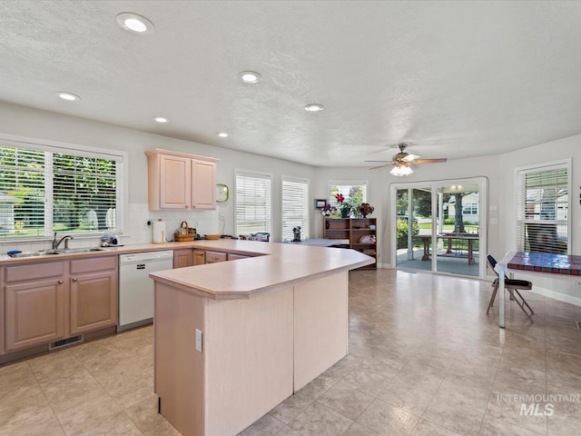 3369 W Monessen Ln, Meridian, ID 83646 - kitchen featuring dishwasher, light brown cabinets, light countertops, a textured ceiling, and a ceiling fan