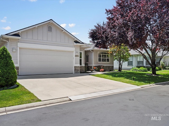 3369 W Monessen Ln, Meridian, ID 83646 - single story home featuring a garage, a front yard, stone siding, driveway, and board and batten siding
