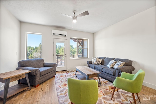 202 Broken Pne, Mccall, ID 83638 - living room featuring an AC wall unit, ceiling fan, baseboards, and wood finished floors