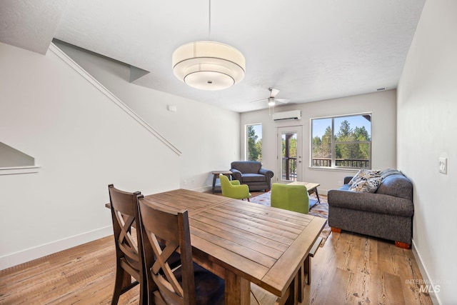 202 Broken Pne, Mccall, ID 83638 - dining area with an AC wall unit, light wood-style flooring, baseboards, and a ceiling fan