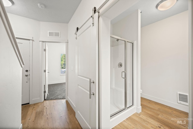 202 Broken Pne, Mccall, ID 83638 - bathroom with baseboards, a stall shower, wood finished floors, and toilet