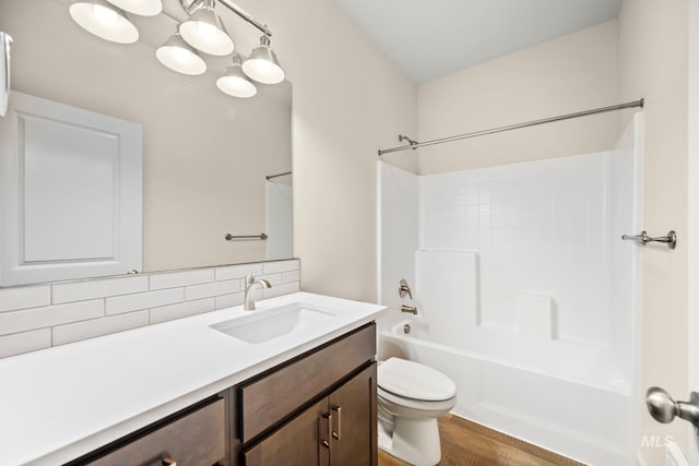 202 Broken Pne, Mccall, ID 83638 - full bath featuring toilet, backsplash, vanity, washtub / shower combination, and wood finished floors