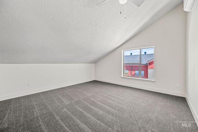 202 Broken Pne, Mccall, ID 83638 - additional living space with a textured ceiling, vaulted ceiling, baseboards, dark colored carpet, and a ceiling fan