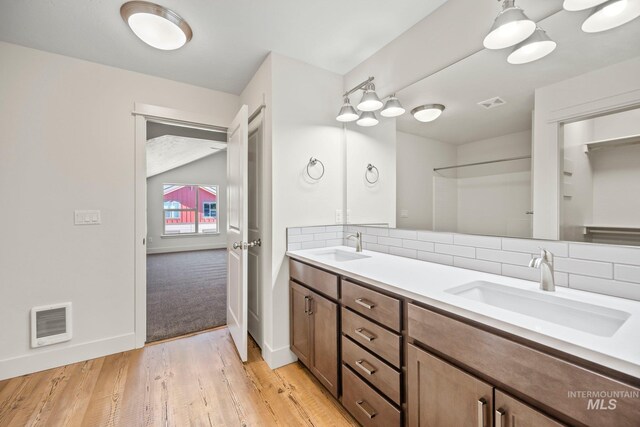 202 Broken Pne, Mccall, ID 83638 - bathroom with tasteful backsplash, baseboards, wood finished floors, and double vanity