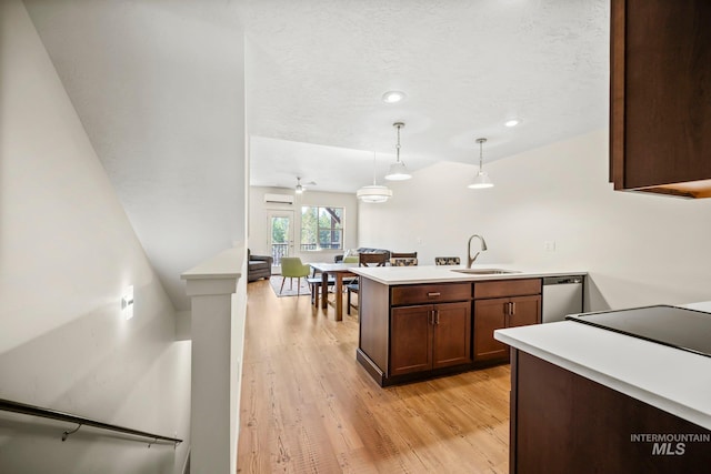 202 Broken Pne, Mccall, ID 83638 - kitchen featuring a sink, a peninsula, light wood finished floors, light countertops, and a textured ceiling