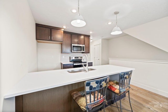 202 Broken Pne, Mccall, ID 83638 - kitchen featuring stainless steel appliances, a sink, recessed lighting, light countertops, and baseboards