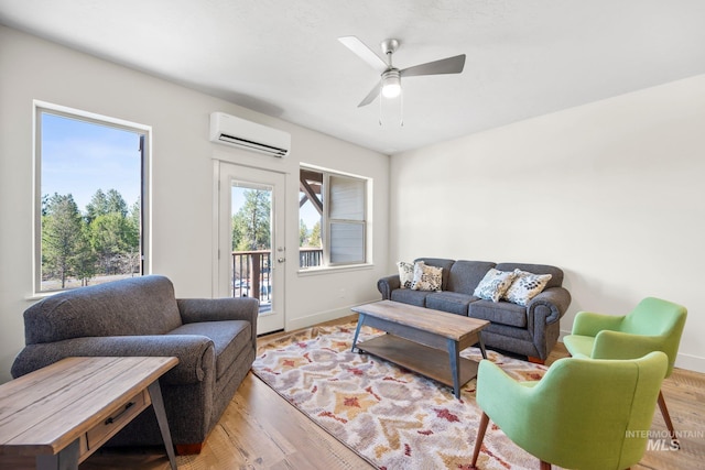 202 Broken Pne, Mccall, ID 83638 - living room with an AC wall unit, baseboards, a ceiling fan, and wood finished floors