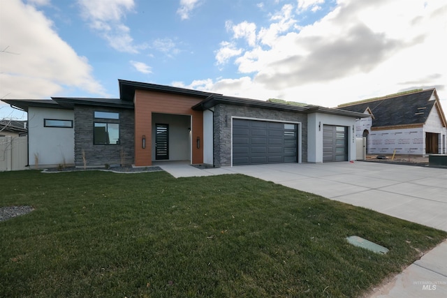 view of front facade featuring a garage and a front lawn