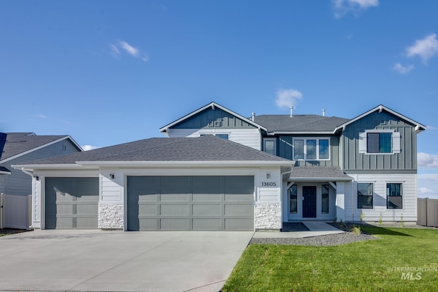 view of front of house featuring an attached garage, driveway, board and batten siding, and a front yard