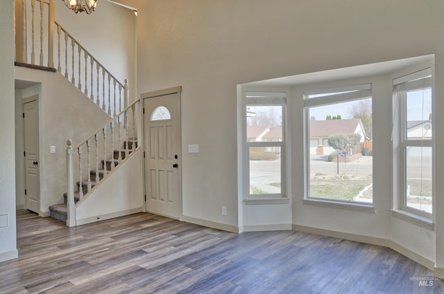 entrance foyer featuring stairs, wood finished floors, and a wealth of natural light