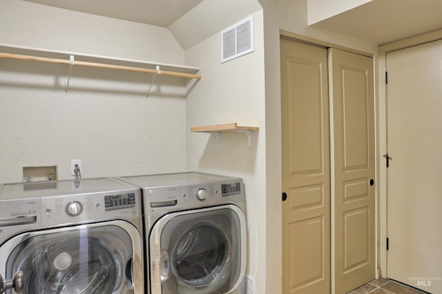 washroom featuring visible vents, laundry area, and separate washer and dryer