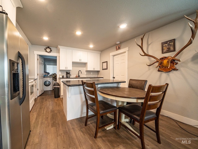 kitchen featuring white cabinetry, sink, dark hardwood / wood-style flooring, stainless steel refrigerator with ice dispenser, and a textured ceiling