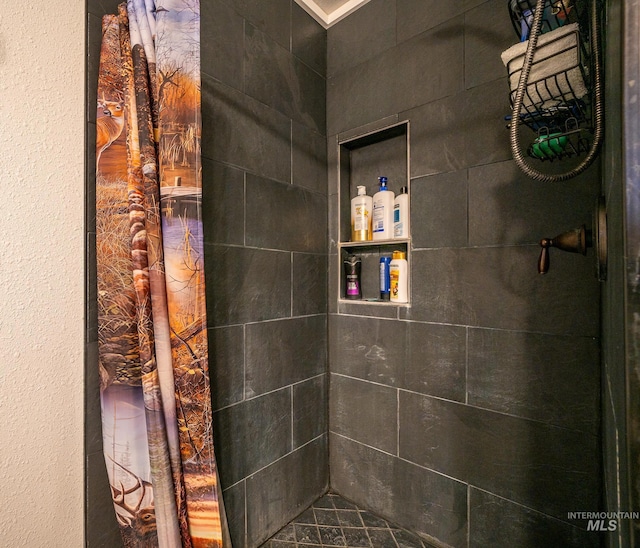 bathroom with a tile shower