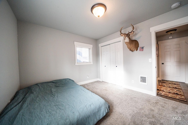 carpeted bedroom with a closet