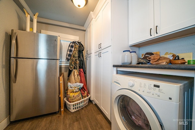 laundry room featuring dark hardwood / wood-style flooring, cabinets, a textured ceiling, and washer / dryer