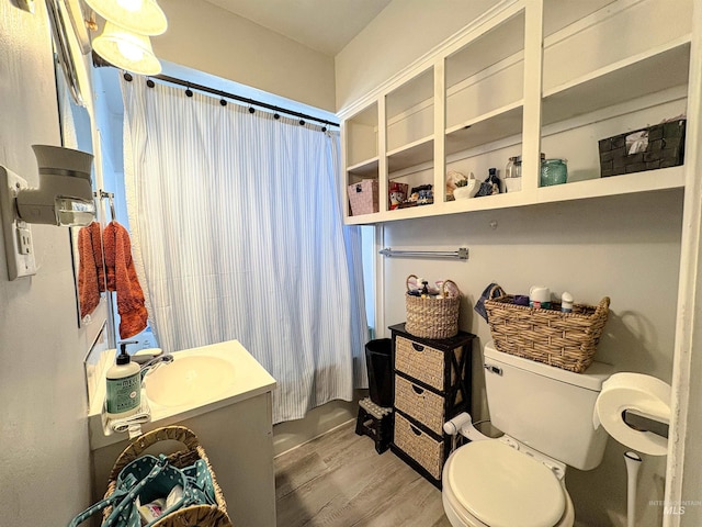 357 Filer Ave, Twin Falls, ID 83301 - full bathroom featuring wood finished floors, toilet, a shower with shower curtain, and vanity