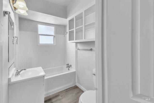 357 Filer Ave, Twin Falls, ID 83301 - full bathroom featuring toilet, washtub / shower combination, wood finished floors, and vanity