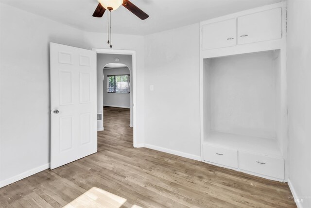 357 Filer Ave, Twin Falls, ID 83301 - unfurnished bedroom featuring arched walkways, light wood-style flooring, and baseboards