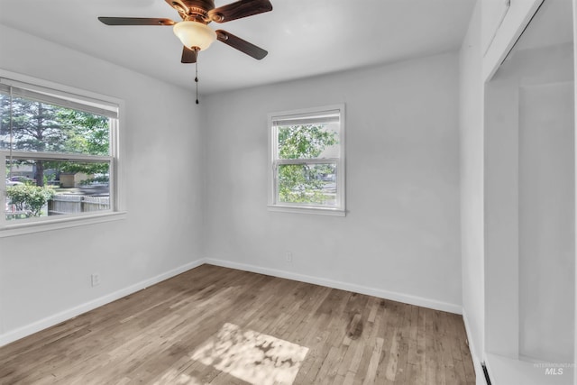 357 Filer Ave, Twin Falls, ID 83301 - unfurnished room featuring plenty of natural light, wood finished floors, baseboards, and a ceiling fan