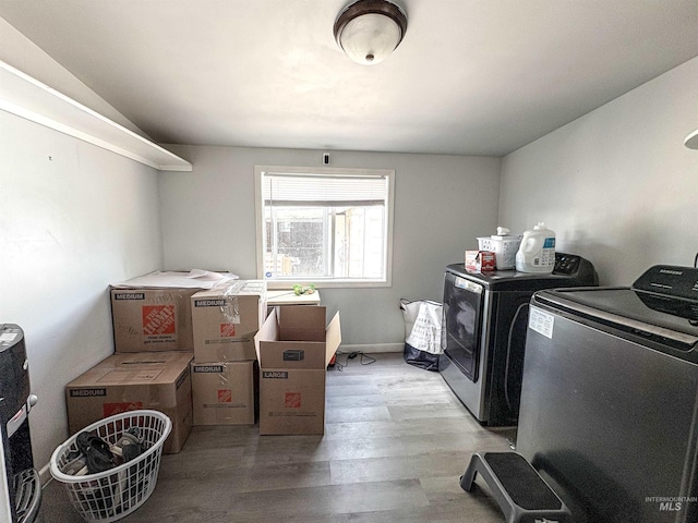 357 Filer Ave, Twin Falls, ID 83301 - washroom featuring separate washer and dryer and wood finished floors
