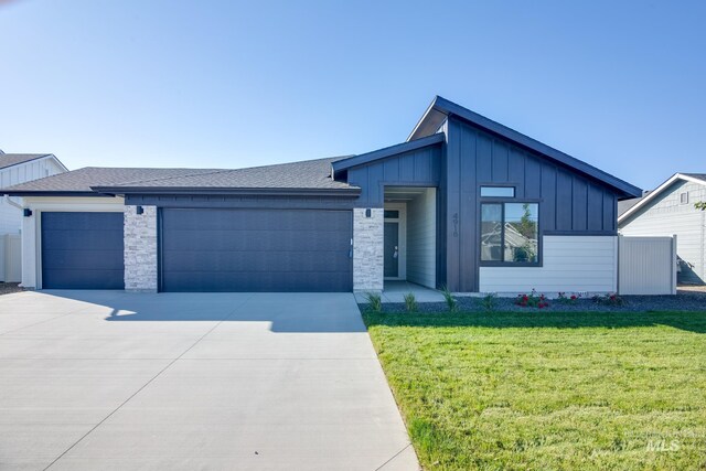 view of front of home with a garage and a front yard