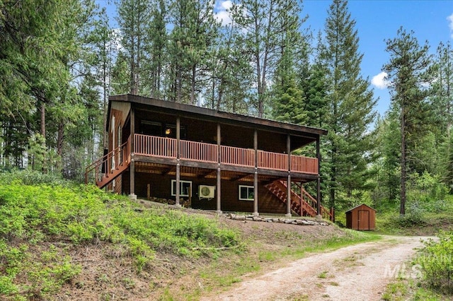108 Panorama Dr, Cascade, ID 83611 - view of front facade with stairway, a wooden deck, dirt driveway, and a forest view