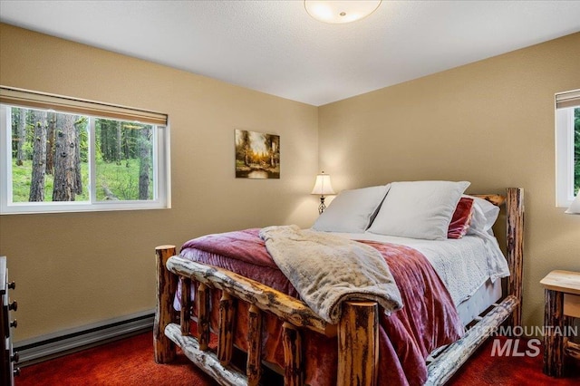 108 Panorama Dr, Cascade, ID 83611 - bedroom with a baseboard heating unit, carpet, and multiple windows