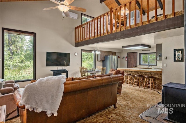 108 Panorama Dr, Cascade, ID 83611 - carpeted living area featuring a ceiling fan, high vaulted ceiling, beam ceiling, and a wall mounted air conditioner