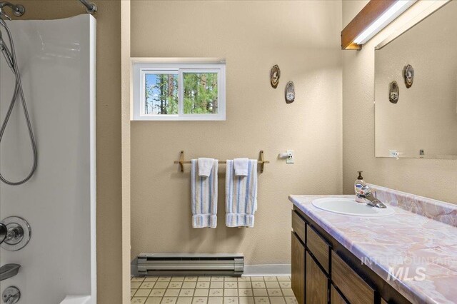 108 Panorama Dr, Cascade, ID 83611 - full bath featuring a baseboard radiator, vanity, shower / tub combination, and baseboards