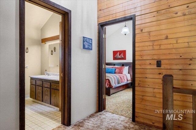 108 Panorama Dr, Cascade, ID 83611 - corridor featuring light colored carpet, lofted ceiling, and wooden walls