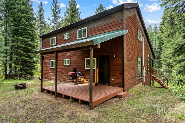108 Panorama Dr, Cascade, ID 83611 - rear view of property featuring an outdoor fire pit, a wooden deck, and stairs