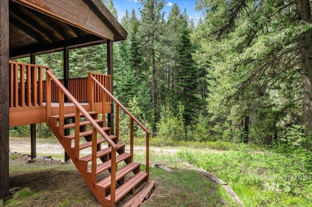 108 Panorama Dr, Cascade, ID 83611 - view of yard with stairs, a forest view, and a wooden deck