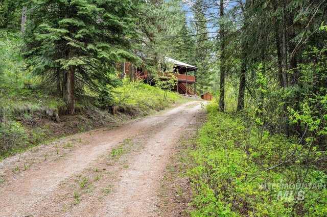 108 Panorama Dr, Cascade, ID 83611 - view of dirt / gravel driveway featuring a view of trees