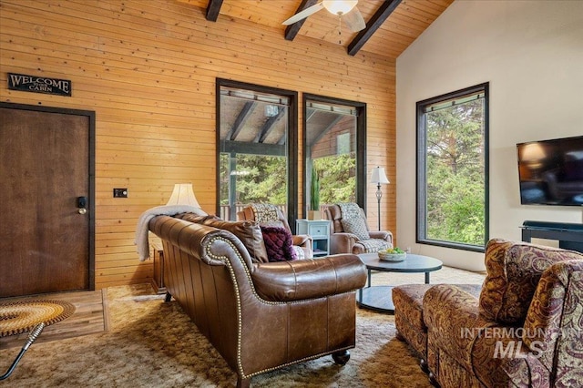 108 Panorama Dr, Cascade, ID 83611 - living room with wood walls, a ceiling fan, wood ceiling with exposed beams, and high vaulted ceiling